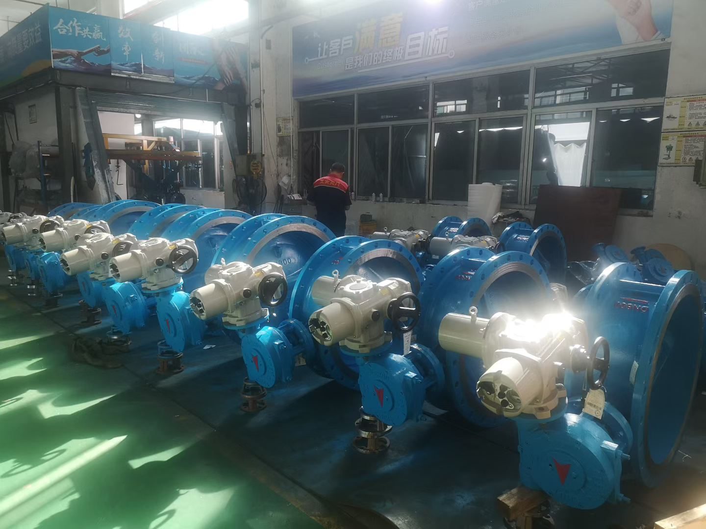 Blue epoxy ball valves lined up in the assembly workshop